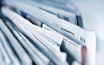 A stack of folded newspapers close-up.