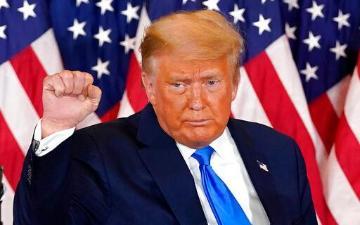 President Donald Trump pumps his fist after speaking in the East Room of the White House, early Wednesday, Nov. 4, 2020. (AP Photo/Evan Vucci)