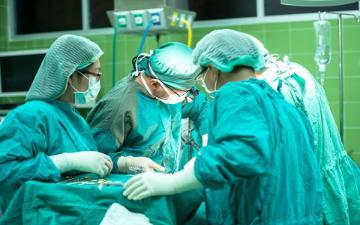 Surgeons performing an operation in an operating room.
