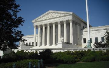 The U.S. Supreme Court building with columns and a flagpole.