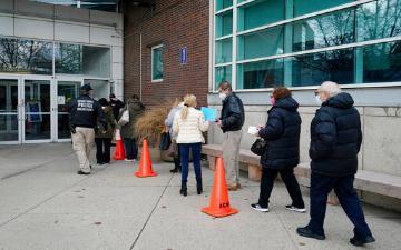 health care workers stand in line for vaccine distribution in New York in January, 2021