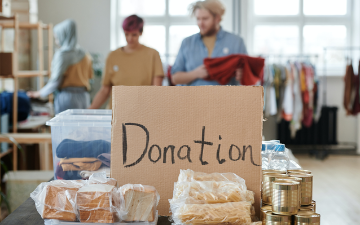 A table set up with objects on top with a sign reading Donation