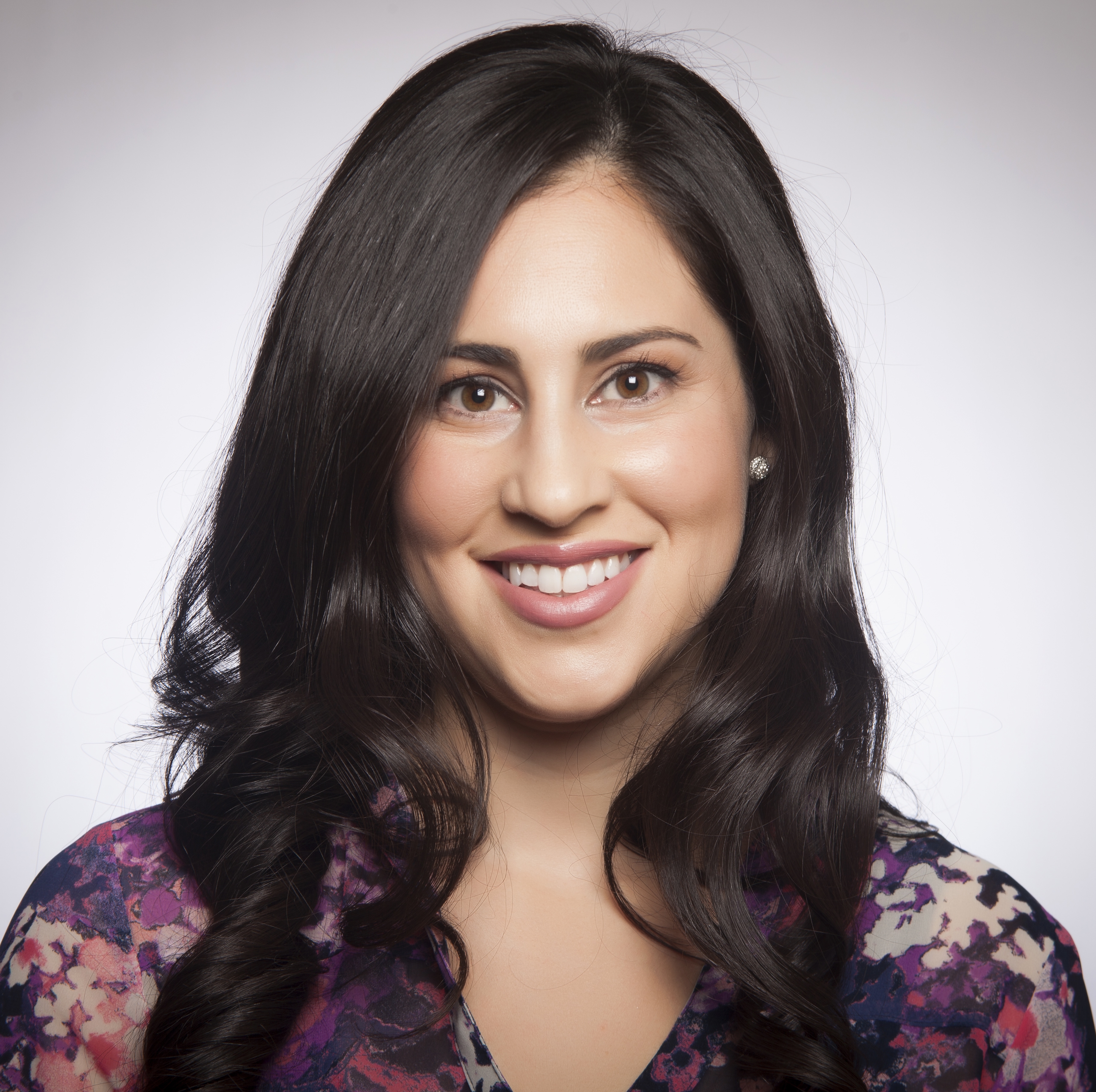 A person smiling in a studio portrait.