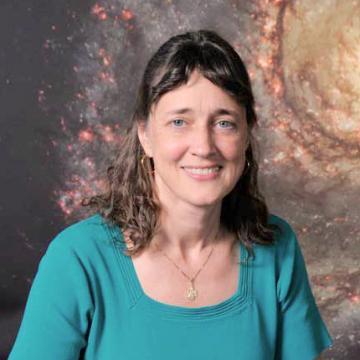 A woman in a teal shirt in front of a galaxy illustration.