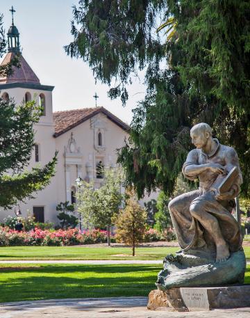 St. Ignatius Statue close up with mission church in the background