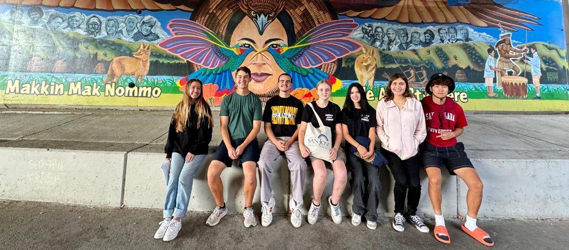 First year Immersion 2024 students in front of the overpass artwork