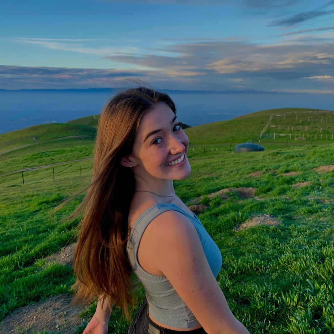 A student in front of a hill 