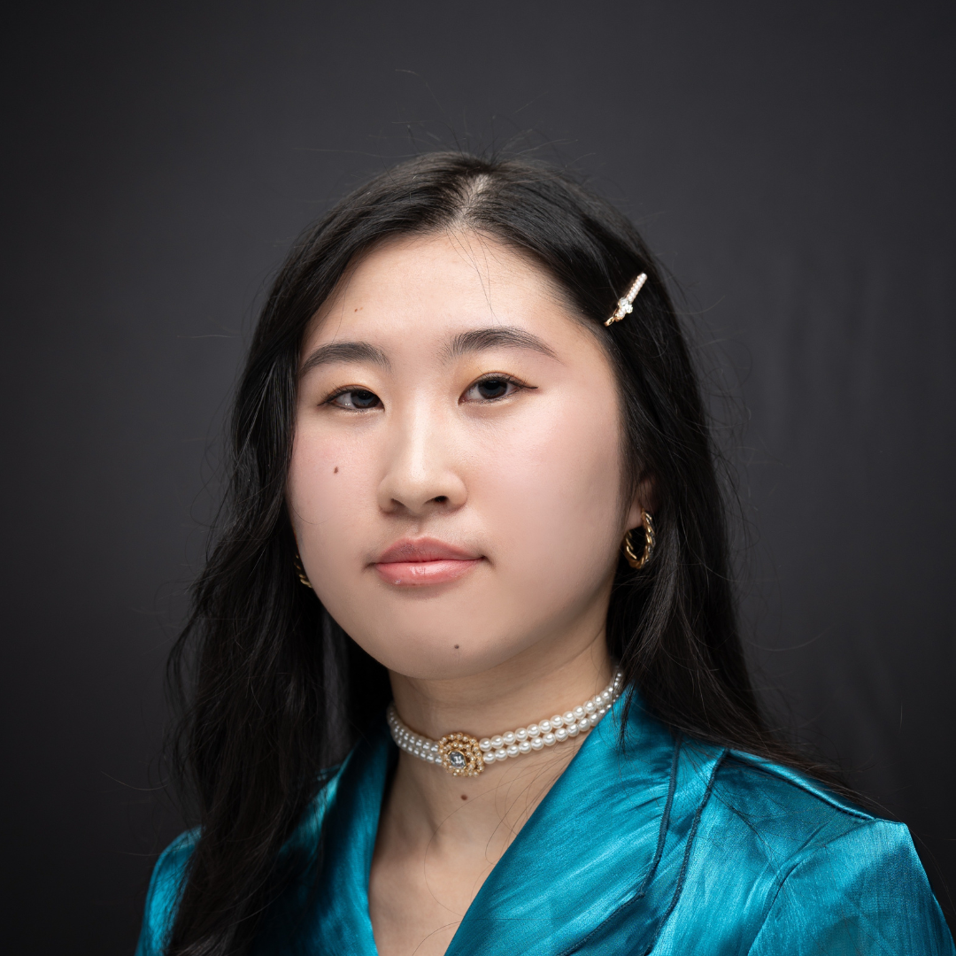 A portrait of a student in front of a grey screen 