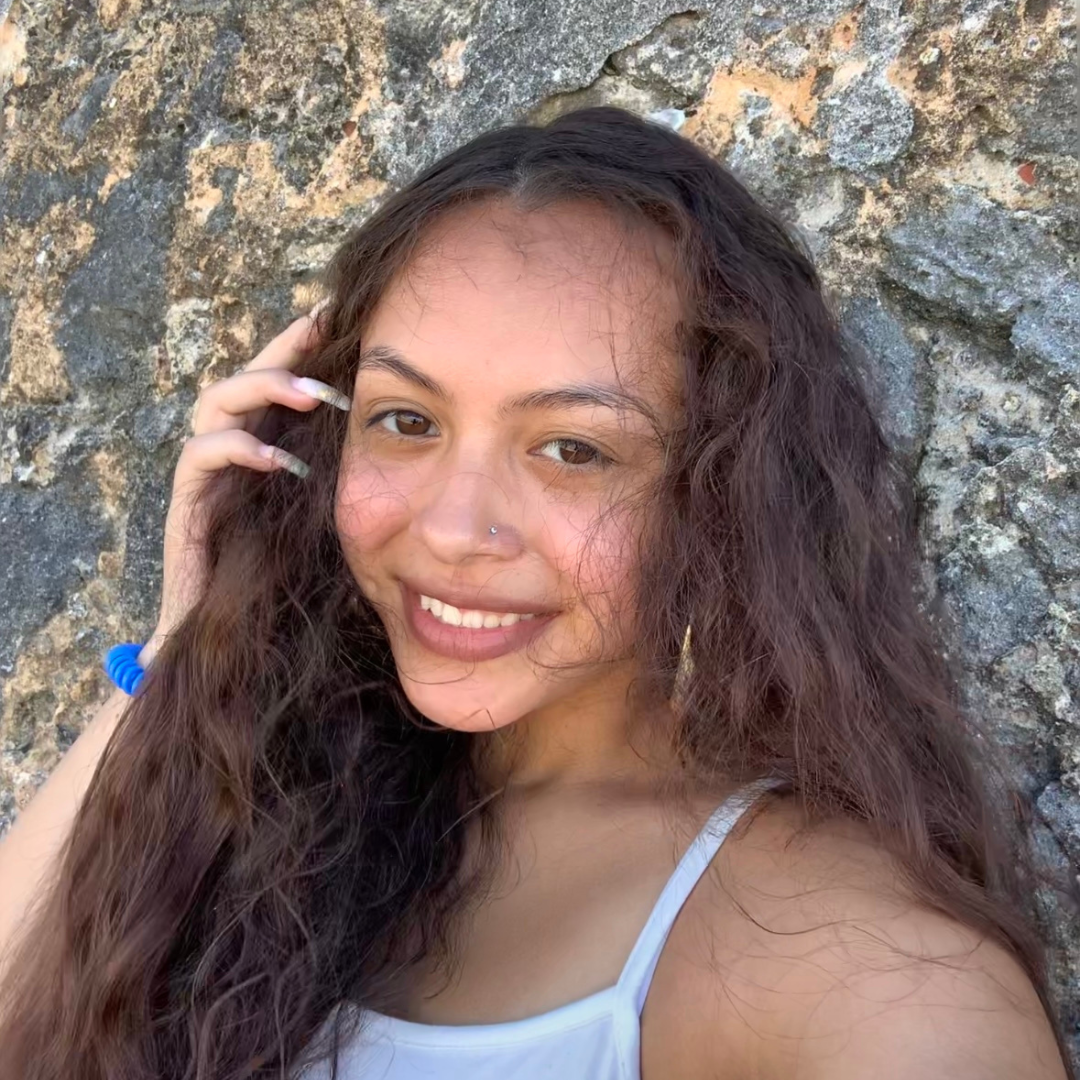 A student in front of some rocks 