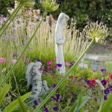 Villa Maria Retreat Center Garden with statures of an angel and Mary