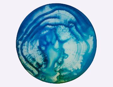 Abstract blue and green circular art resembling a planet's surface. image link to story