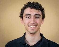 Smiling person against a plain background.