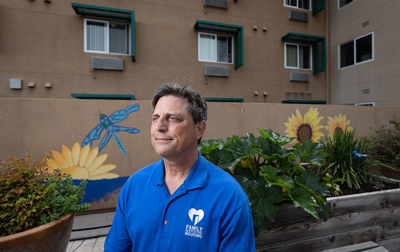 Art Hall sitting on the patio at Family Supportive Housing