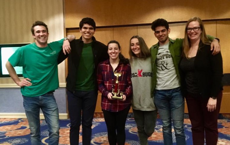 SCU's five ethics bowl team members plus coach posing in a hotel in Atlanta