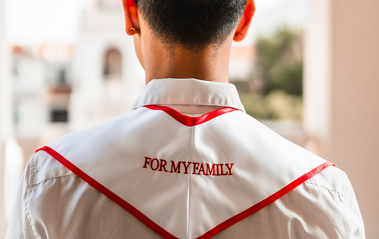 Matthew Mayo '24 wears a graduation stole honoring his family.