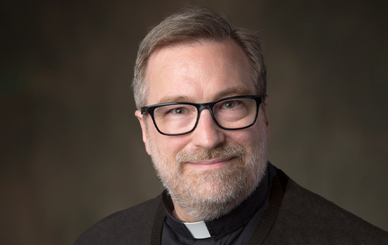 Headshot of Fr. Joseph Mueller, S.J.,  in collar