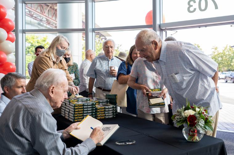 Steve Schott signs his book for a guest