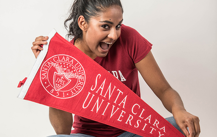 Jo Gopinrath holding an SCU pennant image link to story