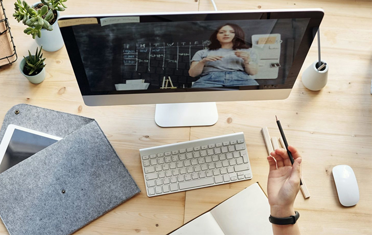 Teacher in front of computer screen