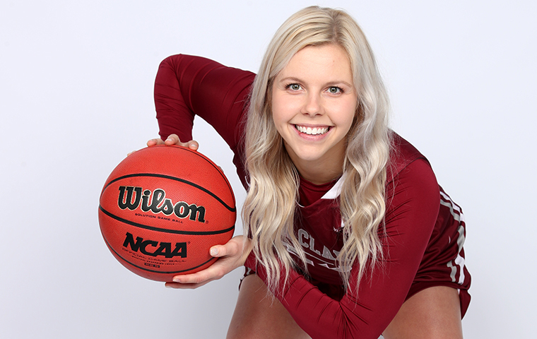 Emily Wolph holds a basketball in a triple threat stance