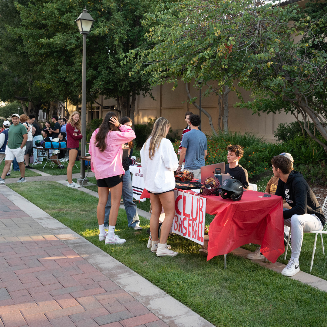 student visiting the Club Baseball table at the Fall involvement Fair 