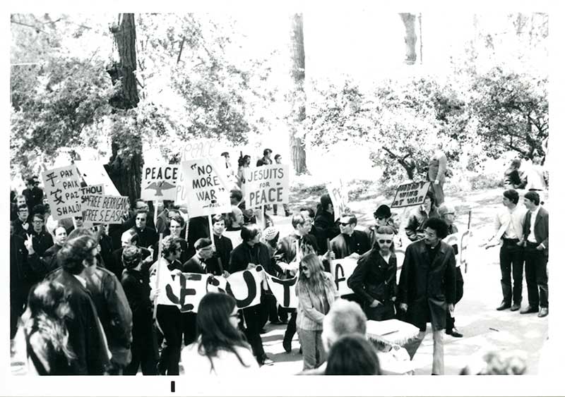 Historical image of Jesuits marching in a protest for peace