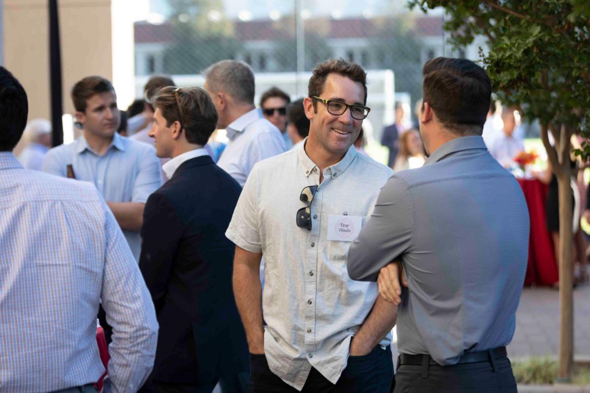 People at an outdoor event, chatting and smiling, RES Photo 17.