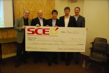 Five people holding a large check from SCE for $3,000.