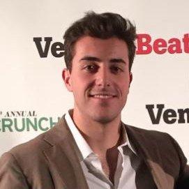 Man standing in front of VentureBeat and Crunch logos backdrop.