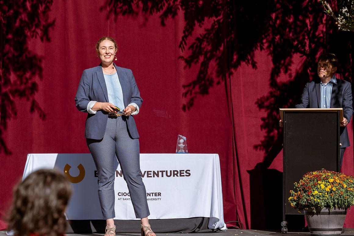 A person presenting on stage at Demo Day BVA 4-21.