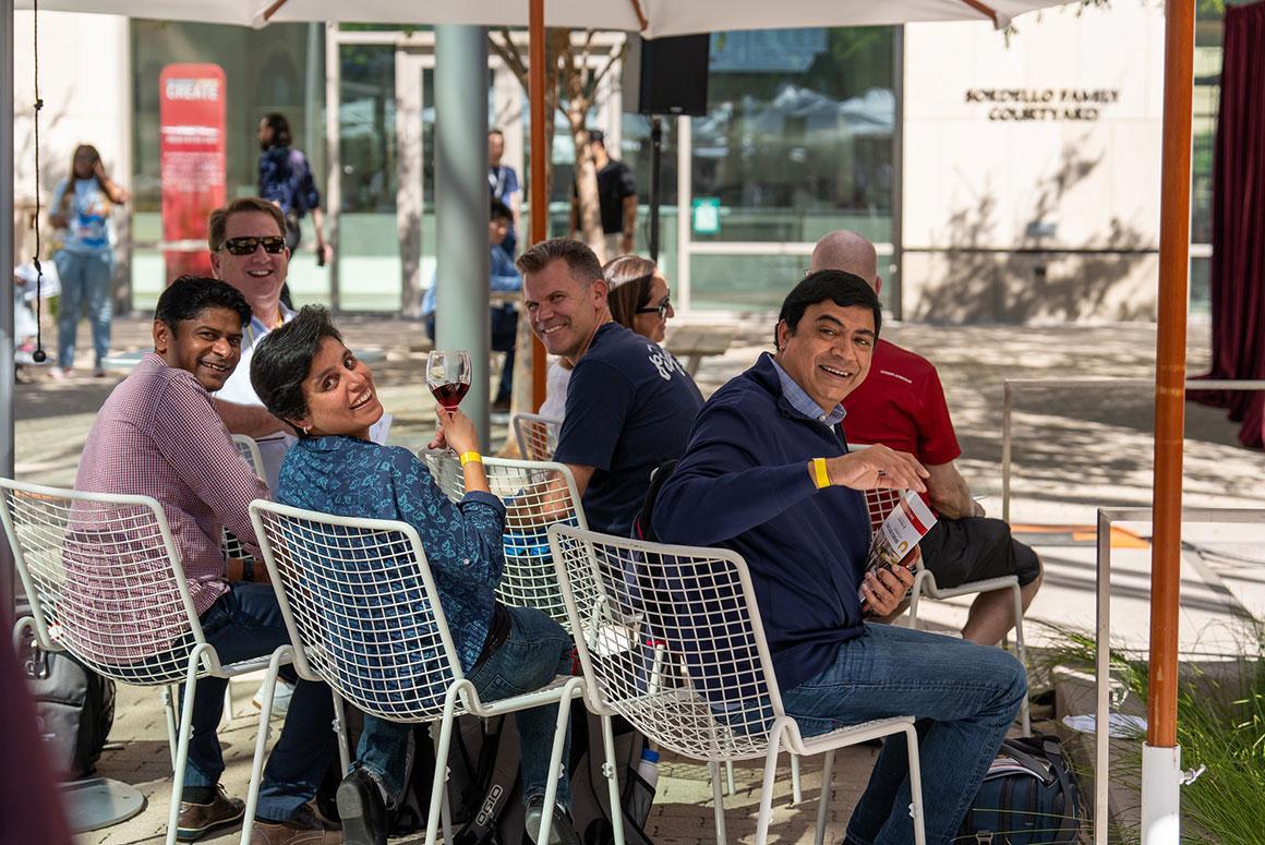 A group of people sitting on chairs outside during Demo Day BVA.