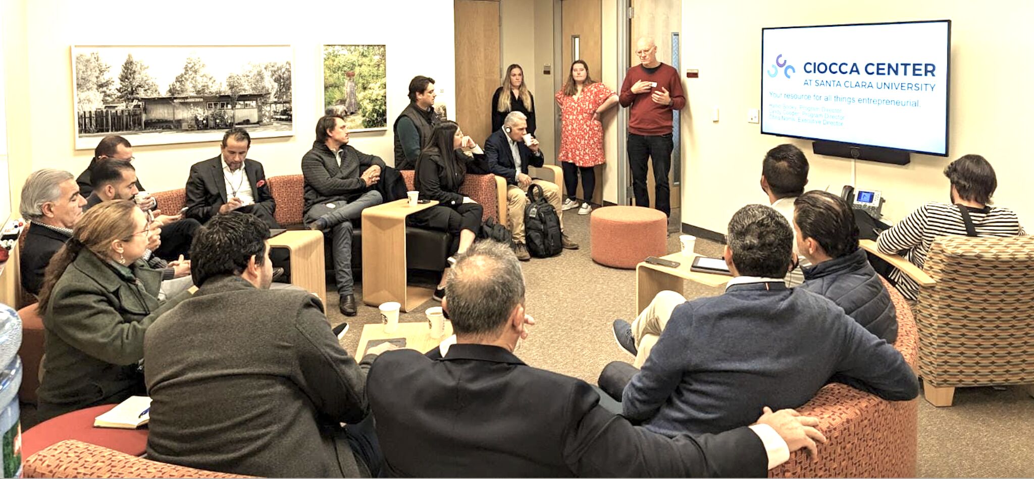 A group of people having a meeting with a presentation on Colombia.