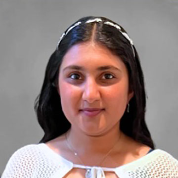 Woman with white headband and top smiling