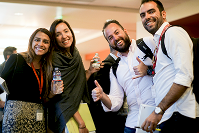 Picture of custom program participants, two female and two male, standing and smiling at the camera.