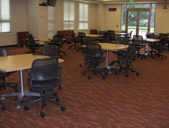 Conference room with tables and office chairs arranged for a meeting.