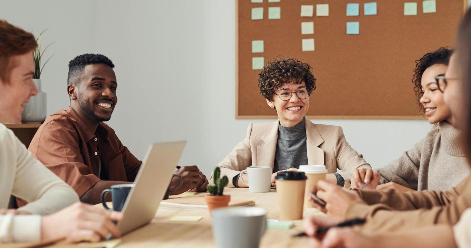 Fulfilled business professionals collaborating in a conference room image link to article