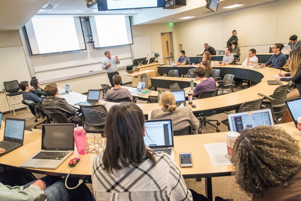 MBA candidates raising their hand in Jo-Ellen Pozner class