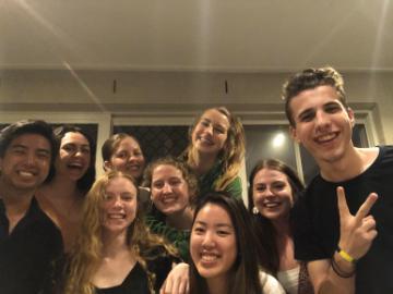 A group of friends smiling and posing indoors.