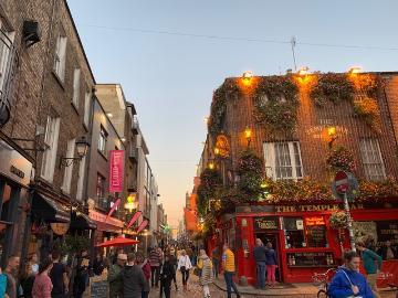 A busy street with illuminated buildings and people.