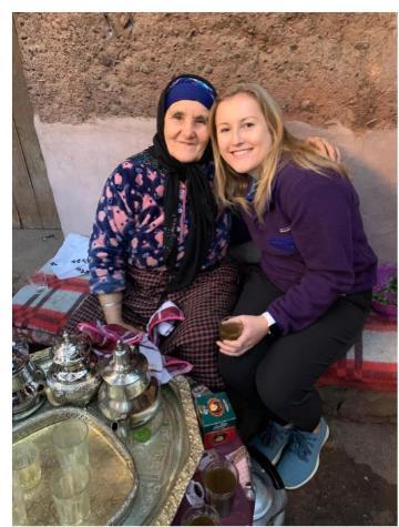 Alt text: Two women sitting together on a bench in Marrakech.