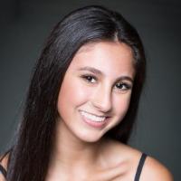 A person smiling in a professional headshot.