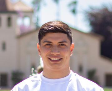 A person standing outdoors in front of a building.
