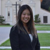 A person standing in front of a white church building.
