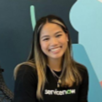 Woman seated near a mural with