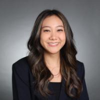 A person smiling in a professional portrait.