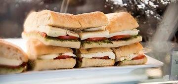 Stacked sandwiches on a plate for dining services catering.