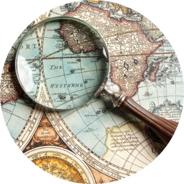 A magnifying glass over a vintage map.