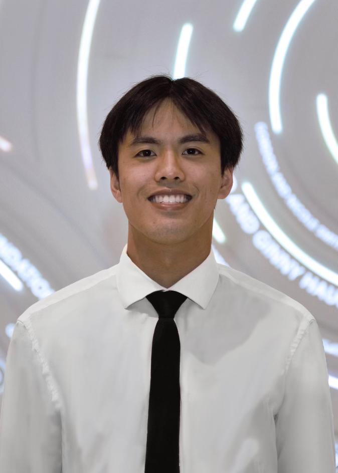 A person smiling in a white shirt and black tie.