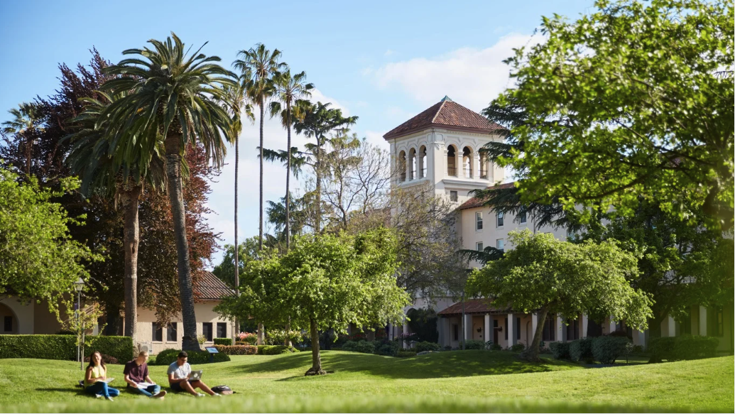 Nobili Hall, SCU, grassy hills with students in foreground