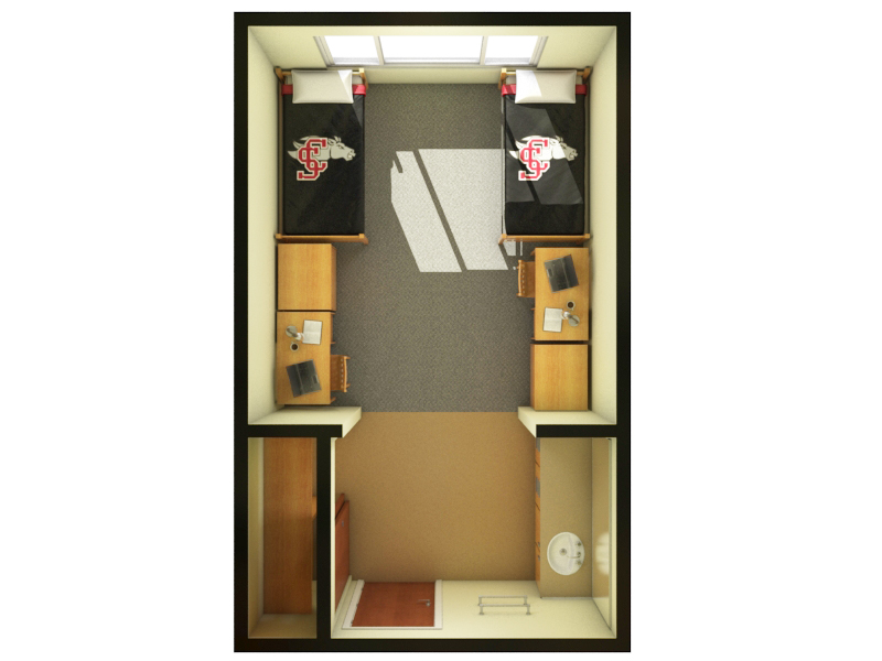 Alt text: Dorm room with two beds, desks, and storage cabinets.